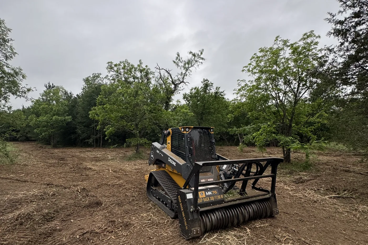Tracked mulcher working through heavy brush